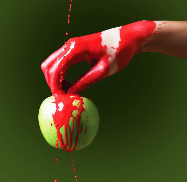 Painted,Hand,With,Apple,Against,Dark,Background