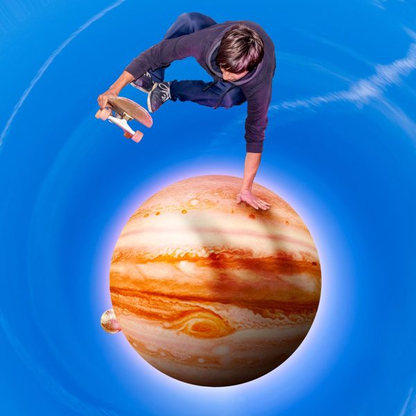 young skateboarder jumping over the jupiter planet aerial view